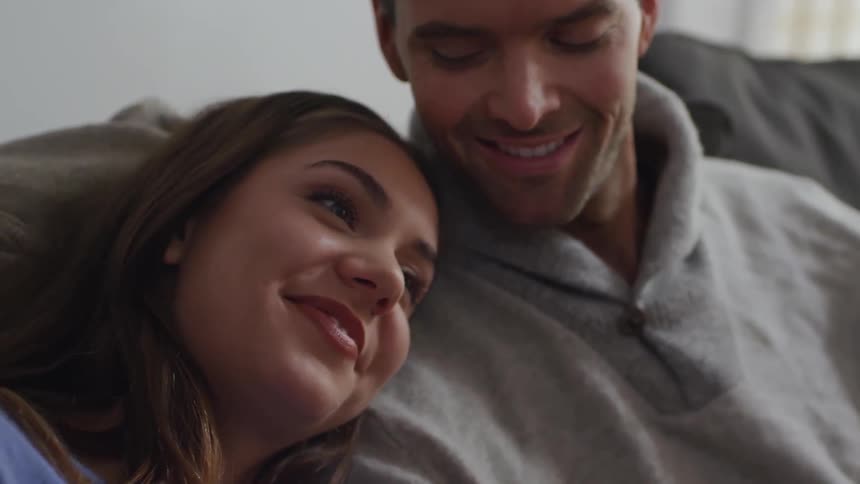 Couple cuddling on a couch