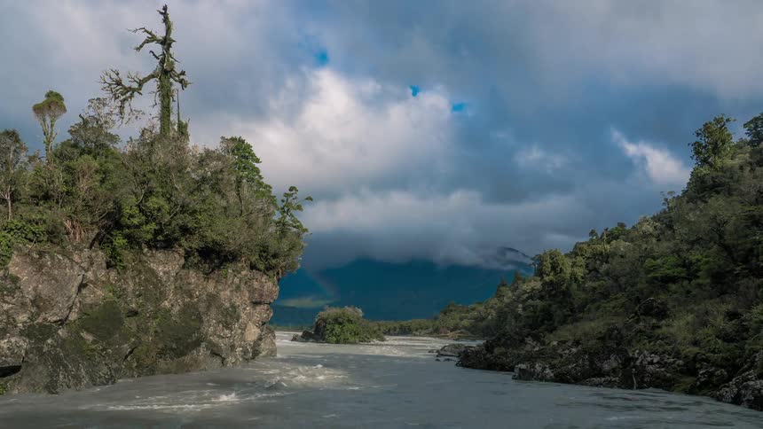 Water and clouds rushing fast by two cliffs