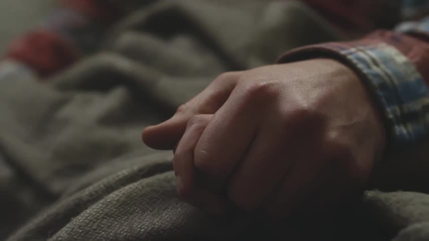 Two people holding hands
