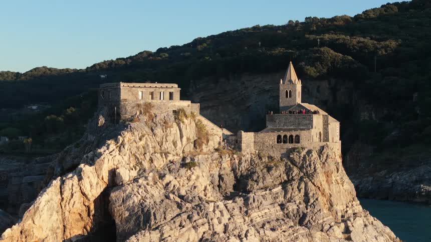 Aerial panorama of a medieval castle on a rocky coastline by the sea