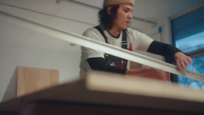 Carpenter with a cap on his head working in a room