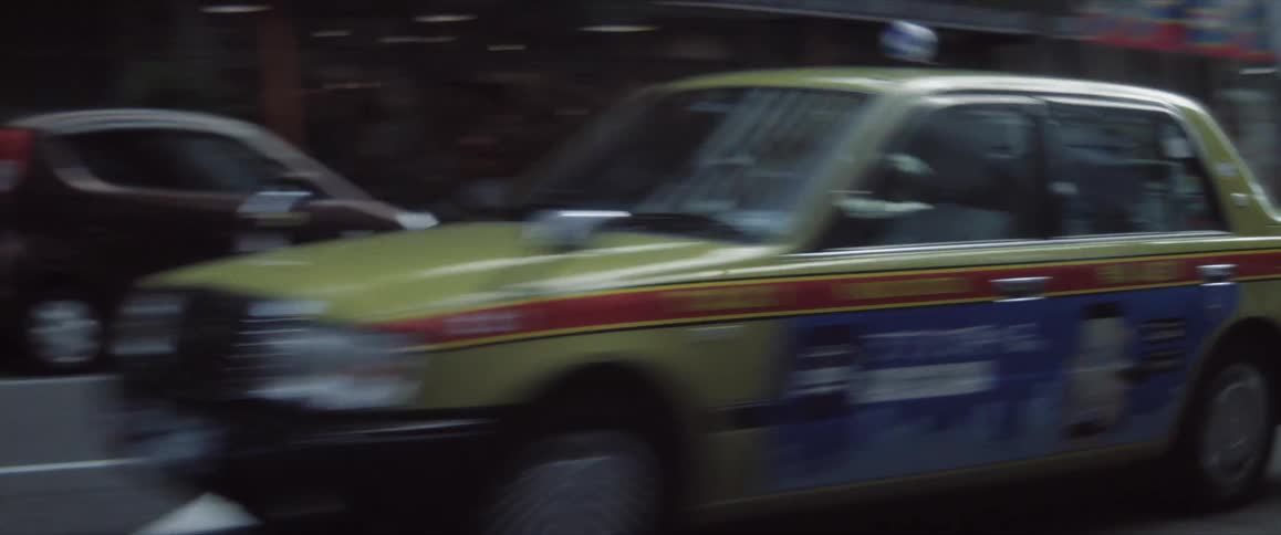 Taxi passing by a highway in a metropolis