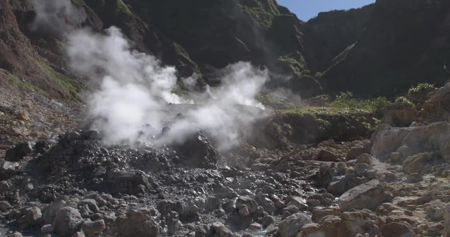 Smoke rises from the ground near mountains