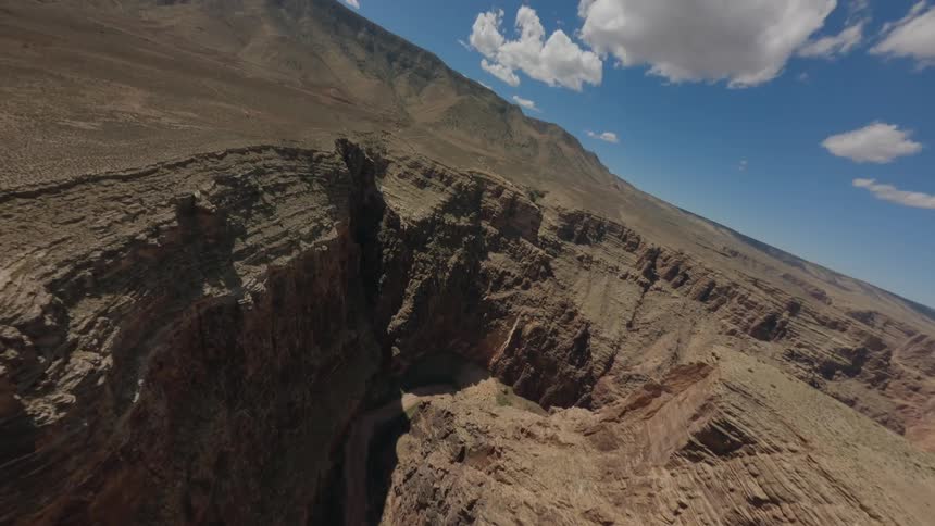 A camera pans overhead on a canyon