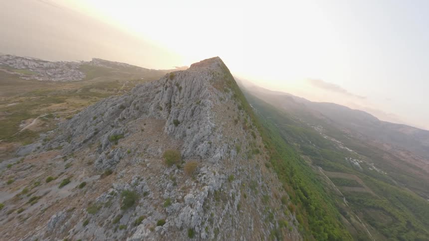 A camera pans over a rocky mountain peak