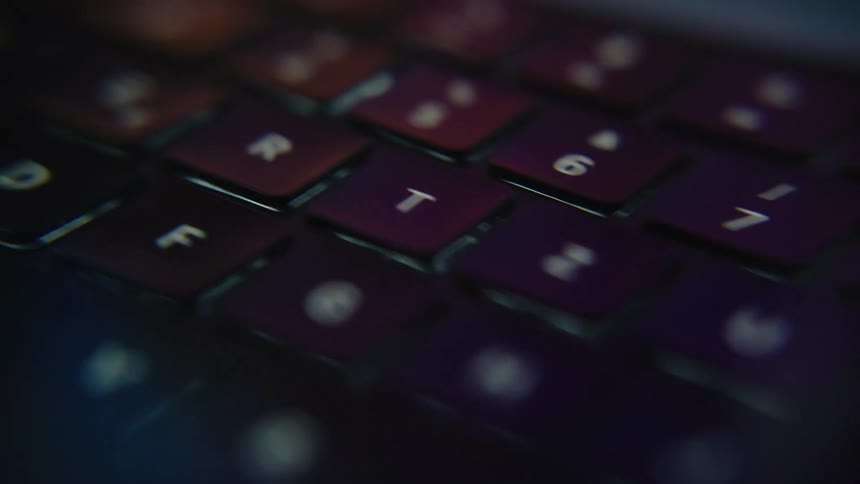 A closeup of a modern macbook keyboard with dynamic movement