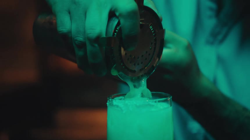 Bartender preparing a cocktail with ice