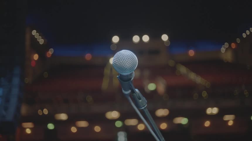 A microphone setup overlooks an empty theater