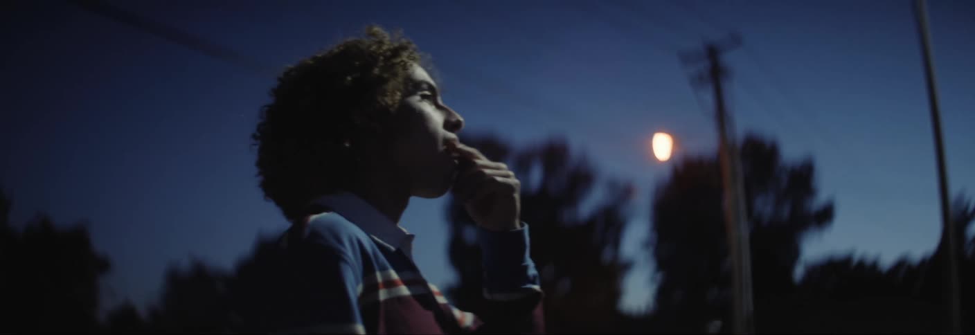 Boy outdoors in the dark of night eating snacks