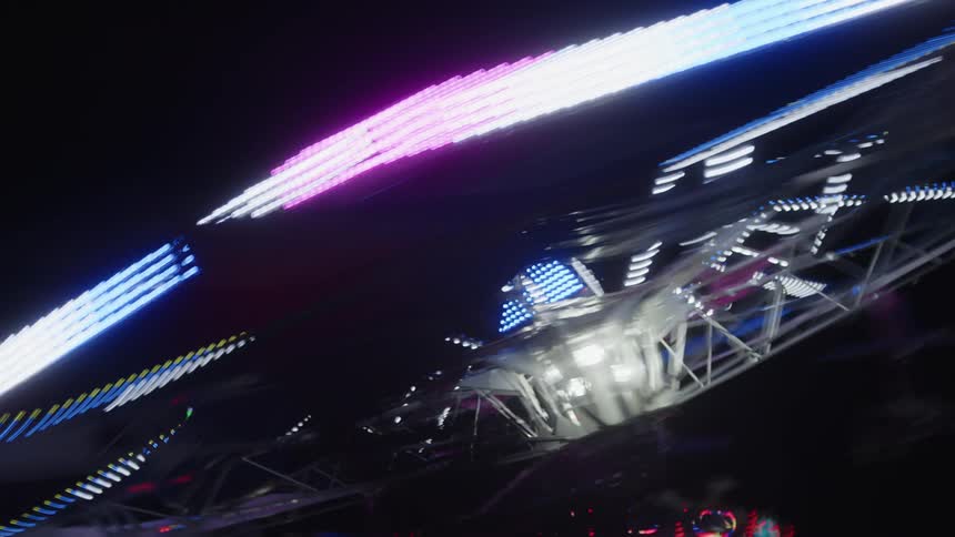 Neon light toy in a moving night park