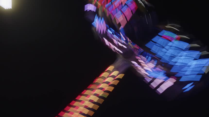 Amusement park ride at night in motion