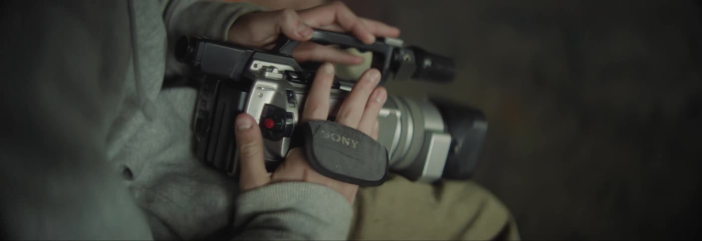 The camcorder is being loaded with a tape