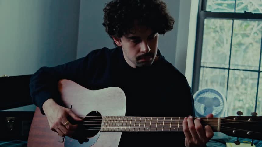 A clip of a person playing guitar