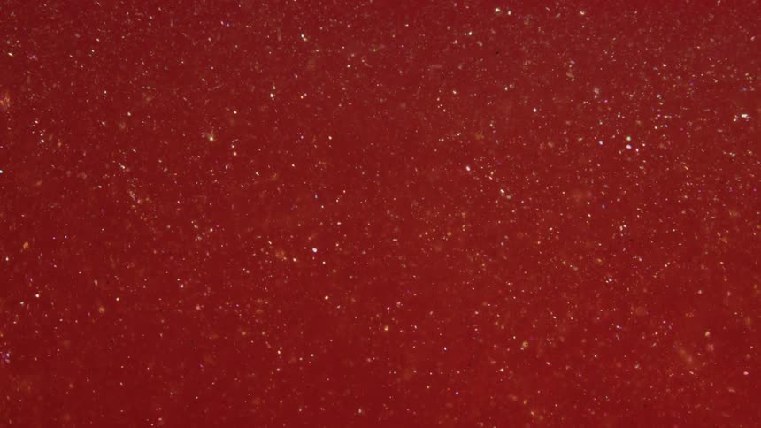 Particles rises through a rust colored mixture