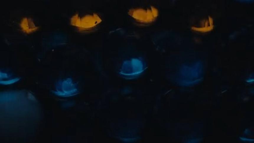 Blue and yellow colored domes periodically shine through the darkness