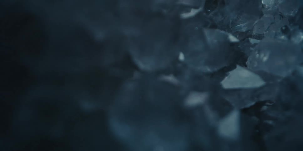 Abstract close up of fragmented ice reflecting flashing lights