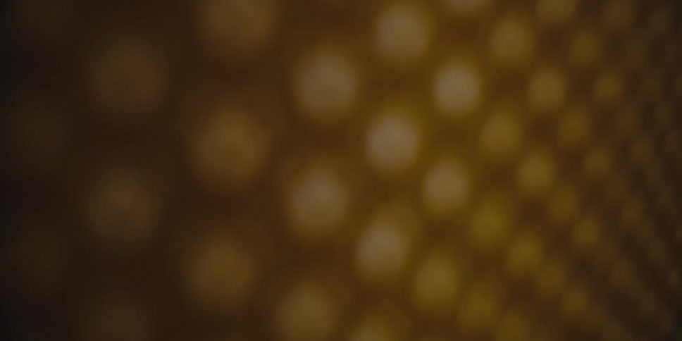 Small light spots expand into larger circles on a brown surface