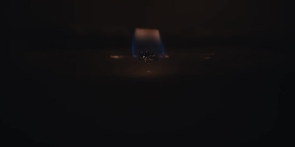 Small flame lighting up in the abstract darkness