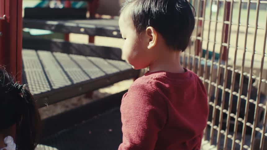 Two small children playing in a playground
