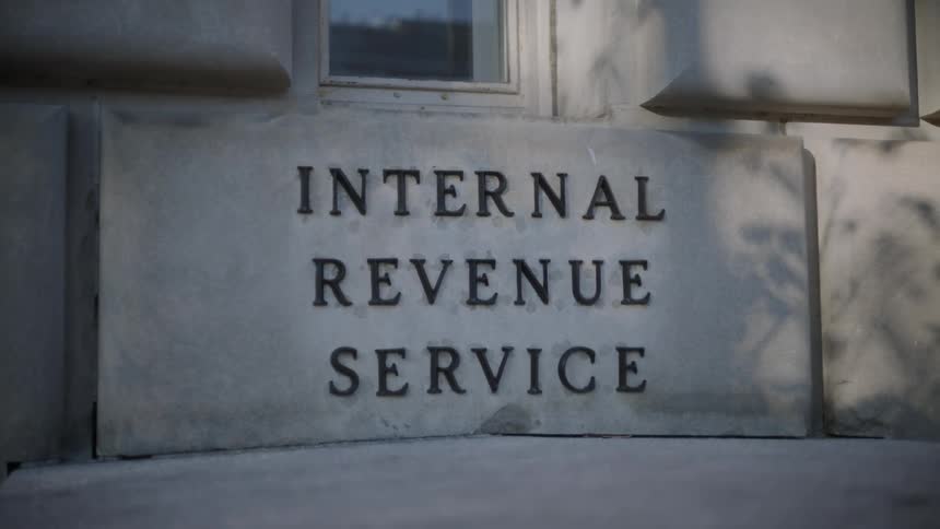 A closeup of a stone sign on a building exterior reading internal revenue service