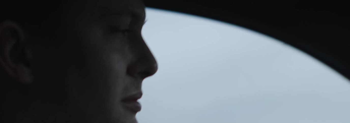 Side portrait of a man driving a car