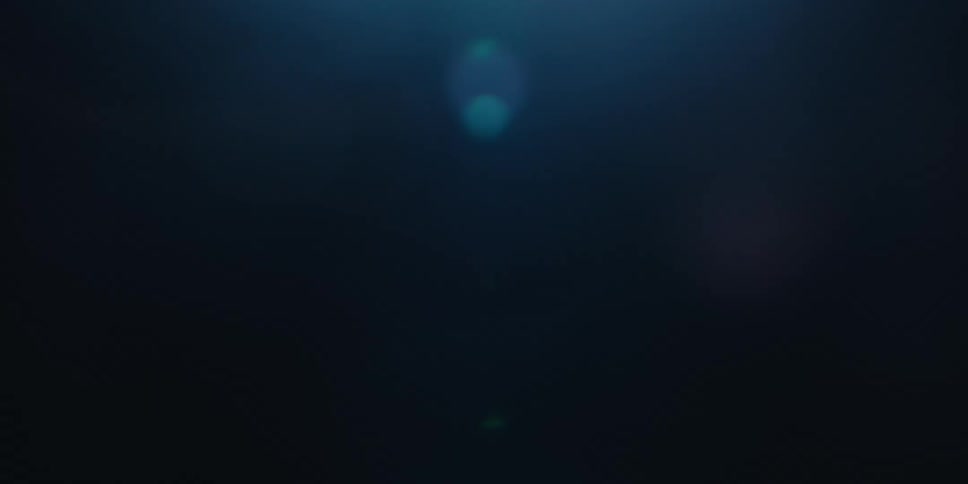 The sun glares through the dark water