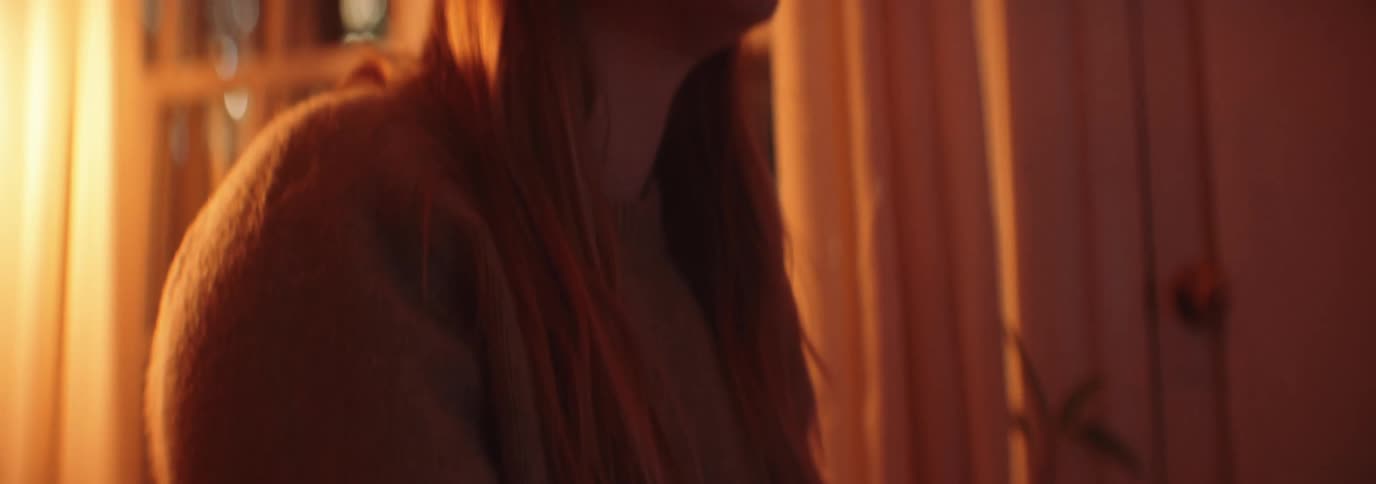 A woman is sitting at home crying