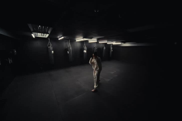 Woman in a gym with flashing lights practicing boxing moves