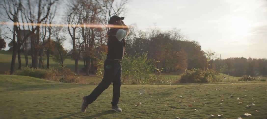A man drives a golf ball off the tee