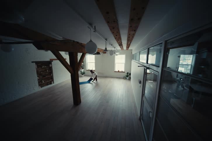 A woman does yoga in the loft