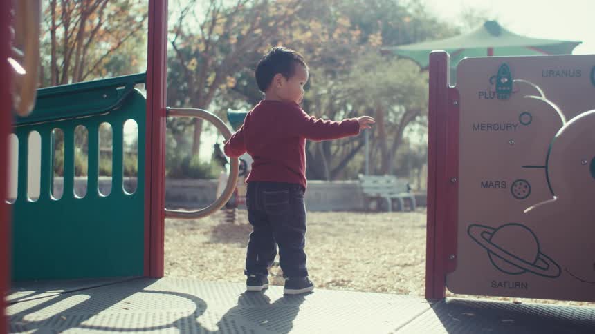 Boy playing and sitting in a playground