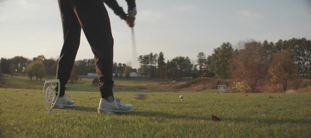 Man taking a golf swing on a course