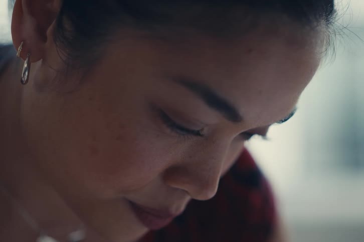 A woman is looking down at something