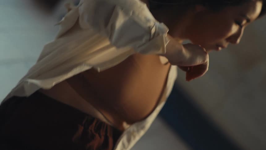 Woman in a ballroom dancing a solo performance