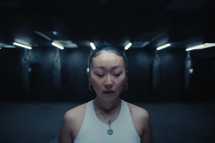 A woman is relaxes in a dark room