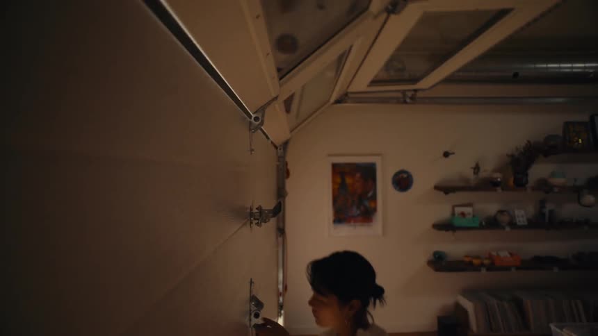 Woman opening a gate from inside the house