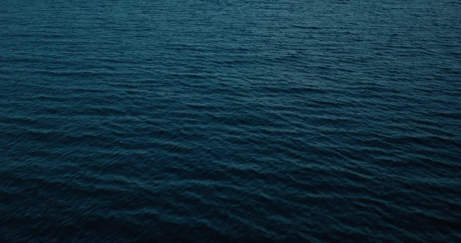 An aerial view of a huge ocean of blue water with its surface having some ripples