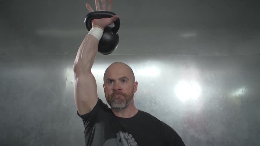 Man swinging kettlebell