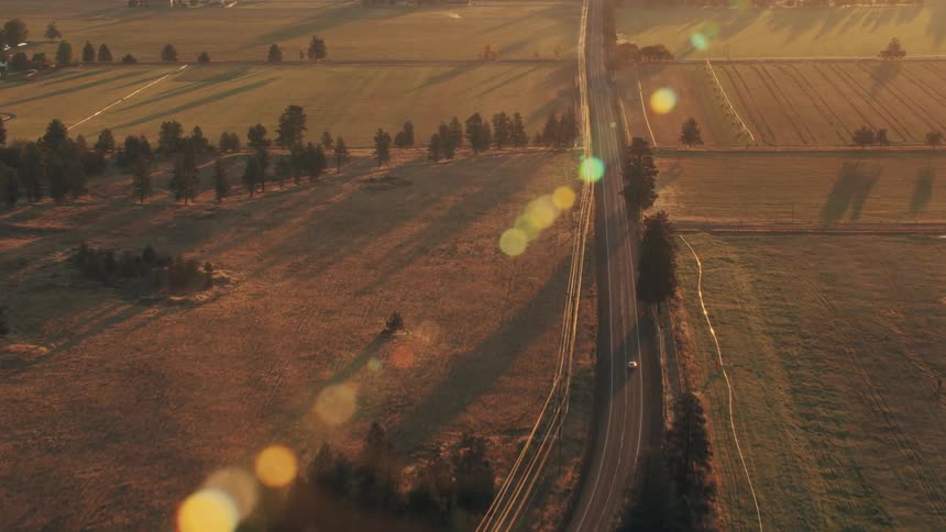 Aerial view of a highway stretching across rural fields