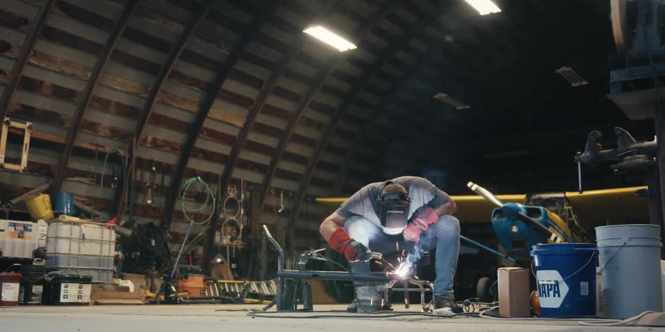 A man welds some iron