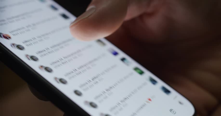 Close up of a thumb scrolling up a contact or notification list on a smartphone