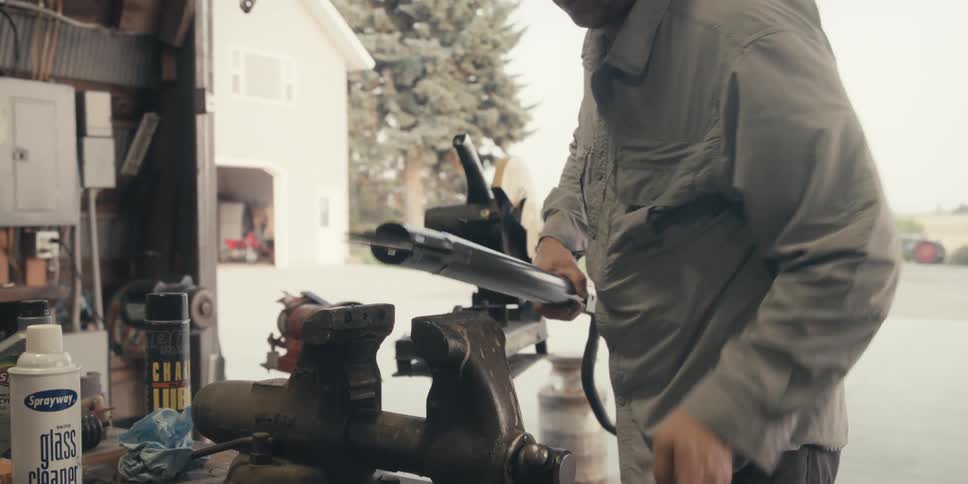 Mechanic turning a crank in a workshop