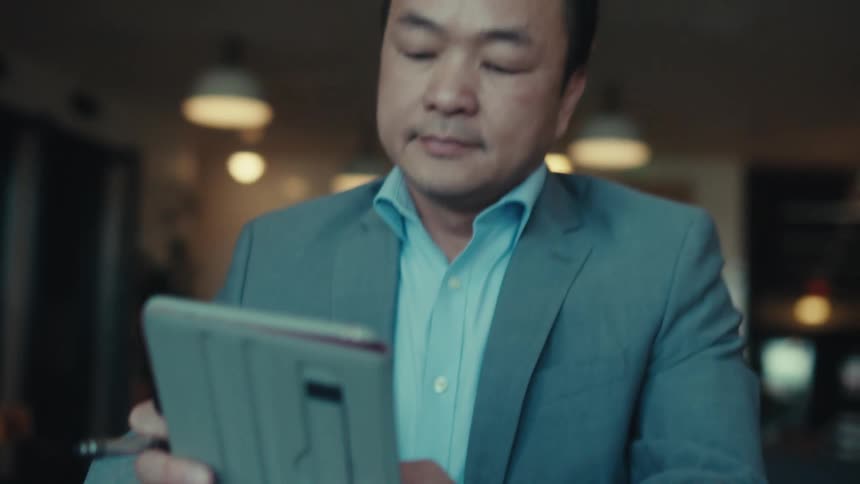 A man is holding his tablet