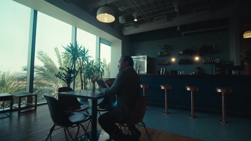 Man sitting at a table in a modern setting