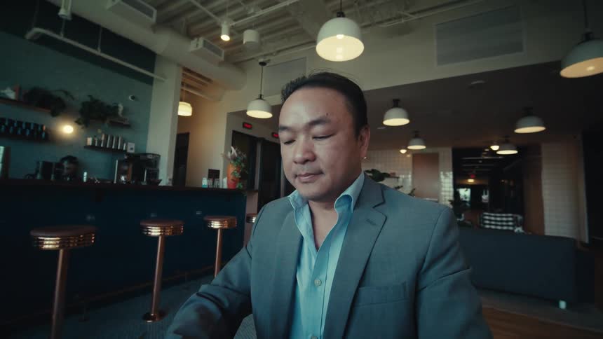 Man sitting at a table and interacting with a tablet