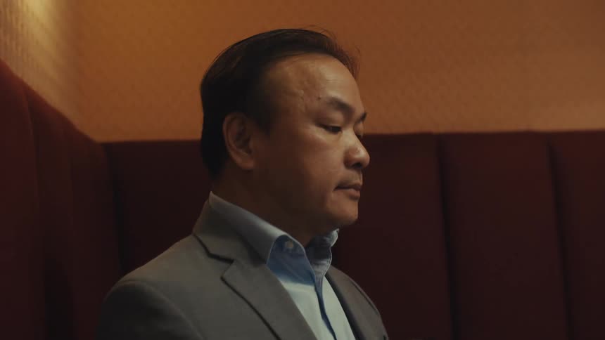 Man in suit sitting using laptop