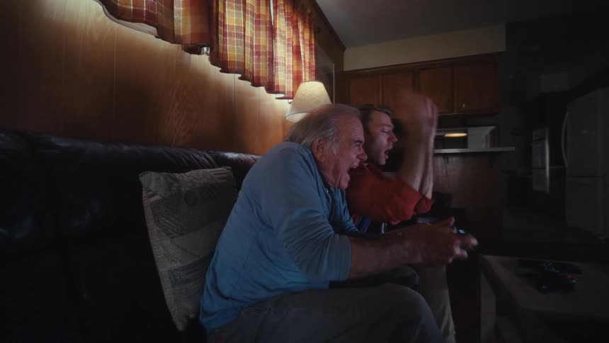 Two men argue while playing a video game