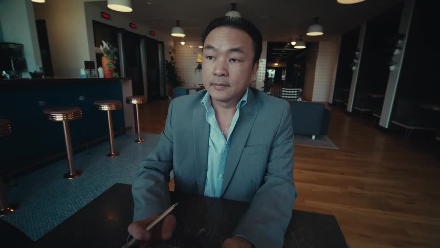 Businessman uses a tablet while sitting in an empty lounge