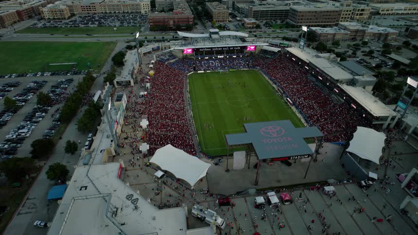 An aerial clip of a stadium in a city