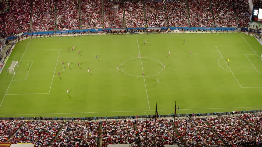 Aerial of a soccer stadium filled with fans in attendance watching a soccer game